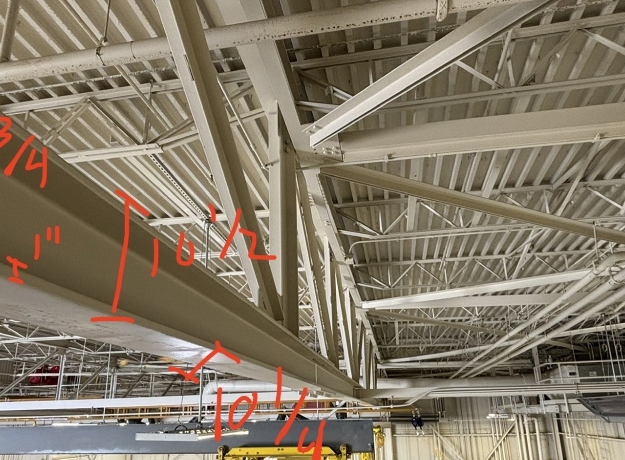 Existing steel roof trusses with representative field dimensions.